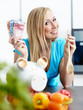 Woman in kitchen saves ready cash with cooking by herself