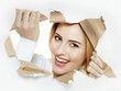 Pretty woman with a smile looking through paper hole