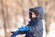 Cute boy playing with snow