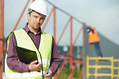 Photo: builder manager worker at construction site builder manager worker at construction site