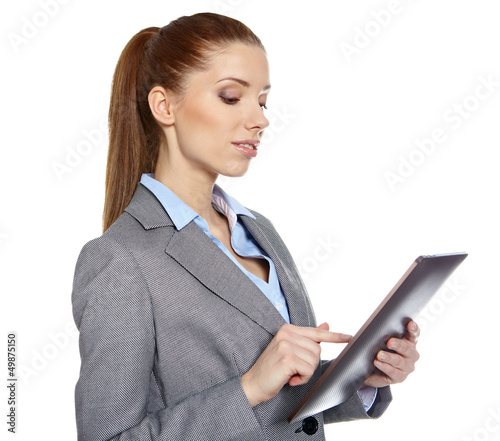 Photo: young attractive business woman uses a mobile tablet computer wi young attractive business woman uses a mobile tablet computer wi
