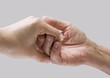 Photo: Young hand give help to old hand Young hand give help to old hand