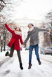 Couple jumping in snow