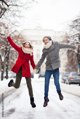 Photo: Couple jumping in snow Couple jumping in snow