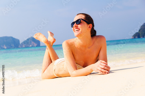 Photo: woman is lying on beach woman is lying on beach