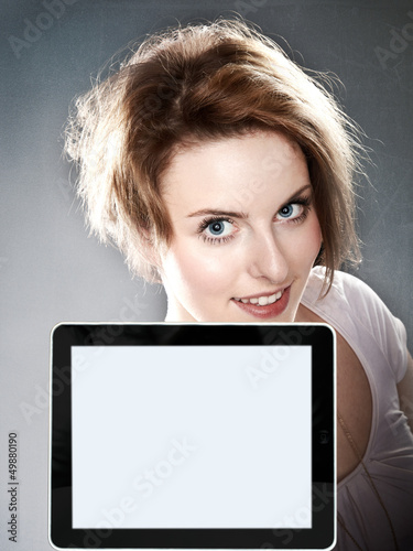 Photo: Beauty woman looking over her tablet pc with copyspace Beauty woman looking over her tablet pc with copyspace