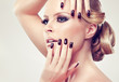 Blonde model  in burgundy manicure and stylish hairstyle