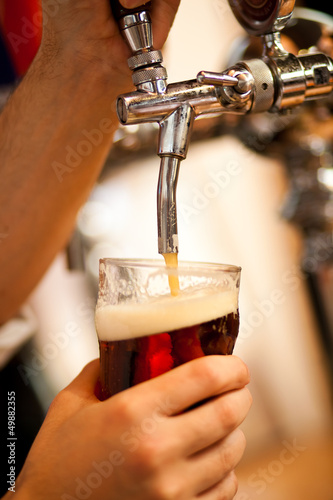 Photo: Bartender drawing a beer Bartender drawing a beer