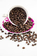 Photo: Cup full of coffee beans on light background Cup full of coffee beans on light background