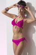 pretty brunette with bikini takes sunglasses