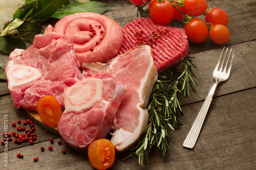 Photo: raw meat selection with pink pepper and herbs raw meat selection with pink pepper and herbs