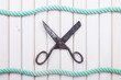 Old scissors on wooden background