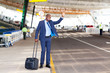 Photo: african american businessman calling taxi in airport african american businessman calling taxi in airport