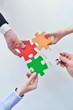 Group of business people assembling jigsaw puzzle