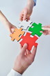 Group of business people assembling jigsaw puzzle