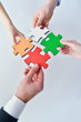 Group of business people assembling jigsaw puzzle