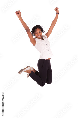 Photo: Young african american business woman jumping, success concept Young african american business woman jumping, success concept