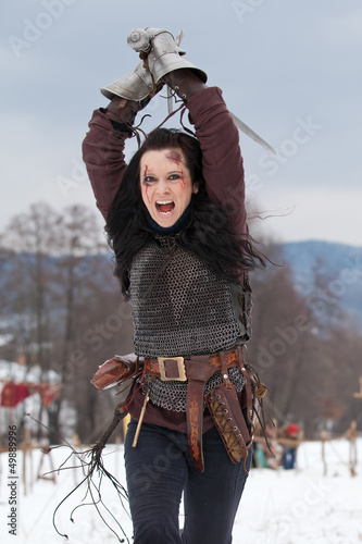 Photo: Woman in the medieval costume with a sword Woman in the medieval costume with a sword