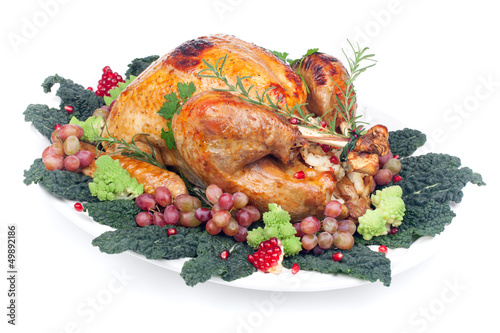 Photo: Garnished roasted turkey on white Garnished roasted turkey on white