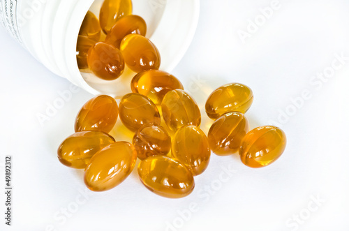 Photo: Rice bran oil pills pouring from the bottle Rice bran oil pills pouring from the bottle