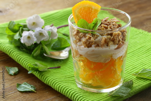 Photo: orange dessert with cream and biscuits in a glass orange dessert with cream and biscuits in a glass