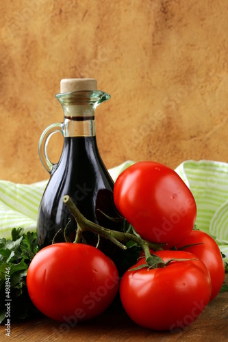 Photo: bottle of balsamic vinegar and fresh tomatoes bottle of balsamic vinegar and fresh tomatoes