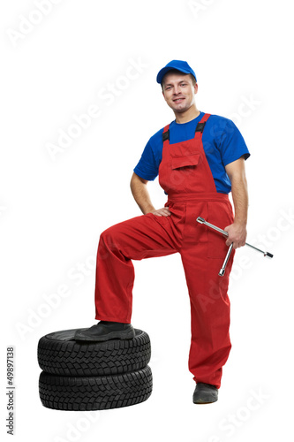 Photo: automobile mechanic with car tire and spanner automobile mechanic with car tire and spanner