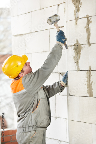 Photo: construction mason worker bricklayer construction mason worker bricklayer
