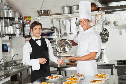 Photo: Waiter Taking Customer's Food From Chef Waiter Taking Customer's Food From Chef