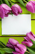 Beautiful bouquet of purple tulips and blank card