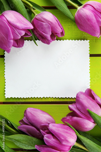 Photo: Beautiful bouquet of purple tulips and blank card Beautiful bouquet of purple tulips and blank card
