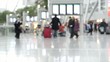 blurred passengers at an airport