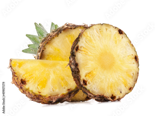 Photo: Juicy slices of pineapple fruits isolated on white background Juicy slices of pineapple fruits isolated on white background