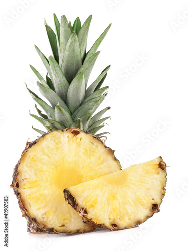 Photo: Juicy slices of pineapple fruits isolated on white background Juicy slices of pineapple fruits isolated on white background