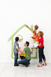 Happy family painting their home together