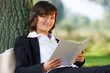 businesswoman reading outdoor in park