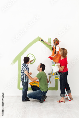 Photo: Happy family painting their home together Happy family painting their home together