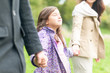 Young happy family of three walking outdoor.
