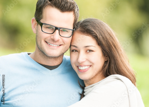 Photo: Portrait of happy young man and woman in park. Portrait of happy young man and woman in park.