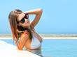 Photo: Young beautiful sexy tanned brunette woman laying on sea beach Young beautiful sexy tanned brunette woman laying on sea beach