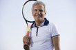 Mature man holding tennis racquet