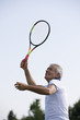 Mature man playing tennis