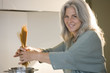 Mature woman cooking spaghetti