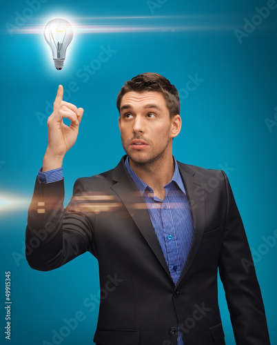 Photo: man in suit with light bulb man in suit with light bulb
