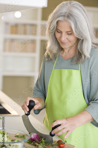 Photo: Mature woman preparing food Mature woman preparing food