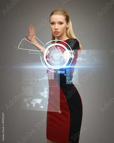 Photo: woman working with virtual touchscreens woman working with virtual touchscreens