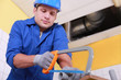 Plumber sawing plastic pipe