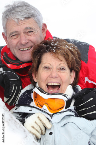 Photo: Senior couple having a great time skiing Senior couple having a great time skiing