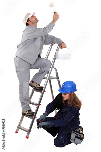 Photo: craftsman painter and female electrician working together craftsman painter and female electrician working together