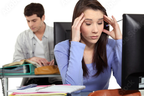 Photo: Student with a headache at a computer Student with a headache at a computer